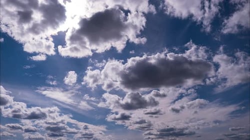 Timelapse of Fluffy Clouds Moving Under the Sun in the Blue Sky
