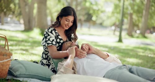 Love, happy couple and laugh at park for picnic, connection or relax together on date for chat