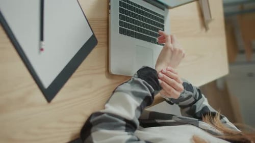 Typing on Laptop, Rubbing Wrist Pain