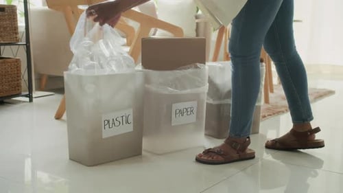 Woman Sorting Trash and Recycling at Home