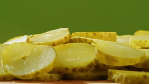 Close Up of Sliced Pickles on Wood