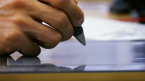 Artist creating digital art with drawing tablet in modern studio