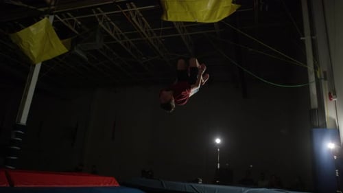 Teen Doing Gymnastics Jumps and Flips on Trampoline