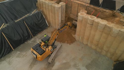 Aerial Ascending Footage of Yellow Crawler Excavator Working on Construction Site Frankfurt Am Main