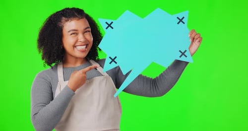 Happy woman, speech bubble and pointing on green screen for social media against a studio
