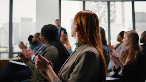 Corporate Meeting with Audience Applauding and Greeting Guest Speaker