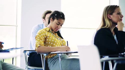 Classroom of adults taking notes during lesson