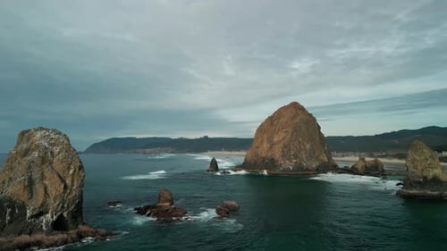 Wide Aerial Shot of Haystack Rock Beach in Coastal Town Cannon Beach Oregon