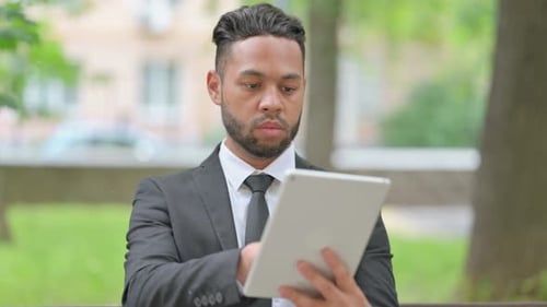 Stylish Man Using Tablet Outdoors in Urban Setting