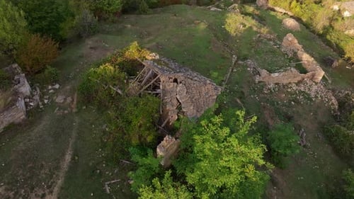 Aerial view of abandoned village ruins and foliage, Bulgaria.