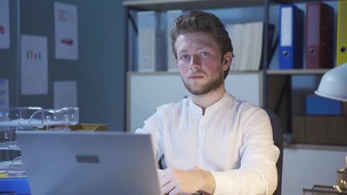 Man Working Late at Computer in Office