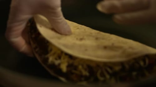 Preparing Delicious Quesadilla with Meat and Cheese Filling