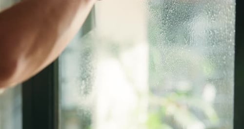 Cleaning, window and hands of person with wiper for hygiene, housekeeping and maid service