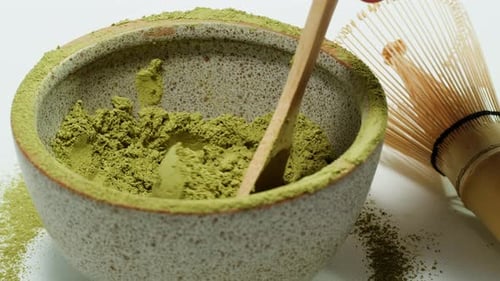 Matcha Green Tea Cooking Process Japanese Powder Green Tea in a Bowl with Bamboo Whisk Macro Close