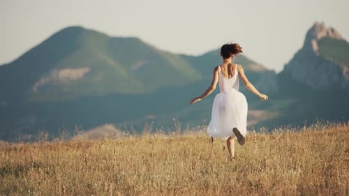 Woman Running Through a Field