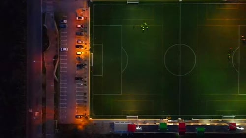 Straight down shot of a football field in the dark with lights sliding right in Santa Ponsa, Mallorc