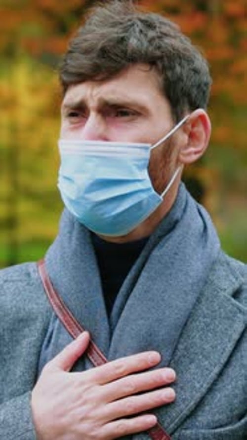 Portrait Sick Young Man with Sad Face and a Protective Mask Coughs Stand in Autumn Park Virus Face