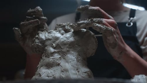 Clay Sculptor Forming Artwork With Hands