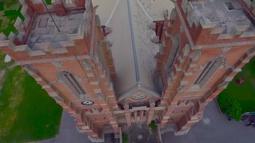 A beautiful old Church top close up aerial view, Red building of the Church, Green trees and grass a