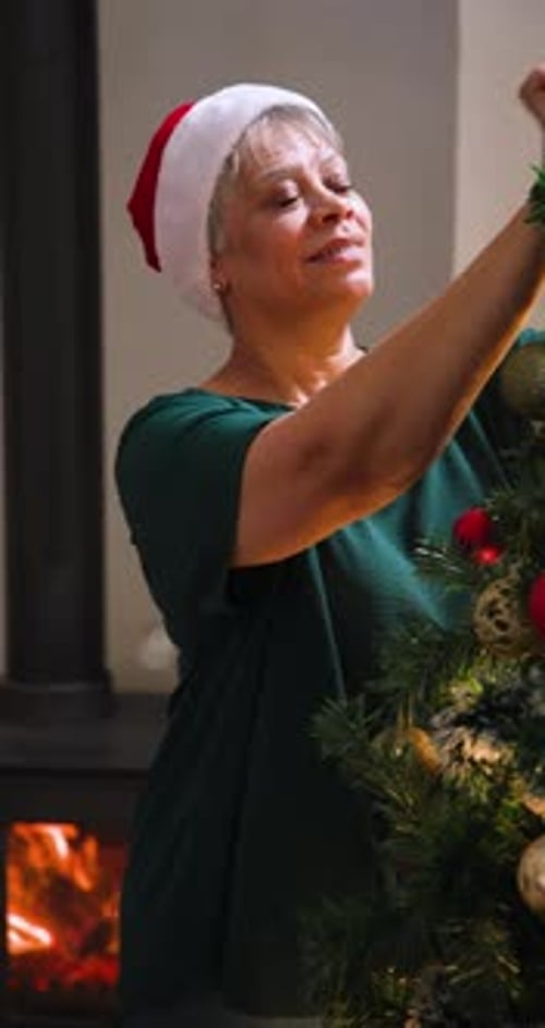 Woman Decorates Christmas Tree in Cozy Home