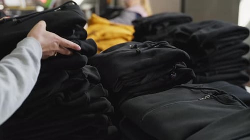 Women Sort and Pack Clothes in Factory Concept of Choosing Clothes