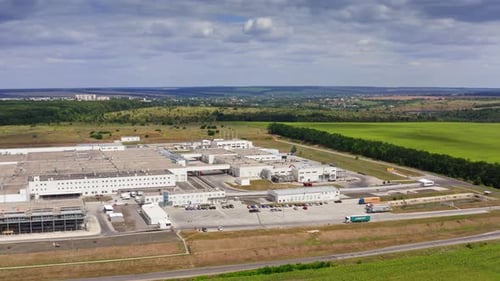 Industry on field. Large territory of industrial plant on green nature background under blue sky.
