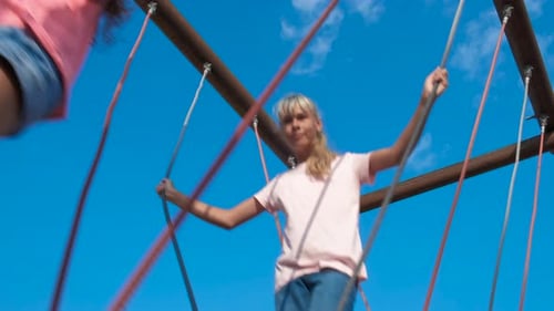 Kids Enjoying Rope Bridge Climbing Structure