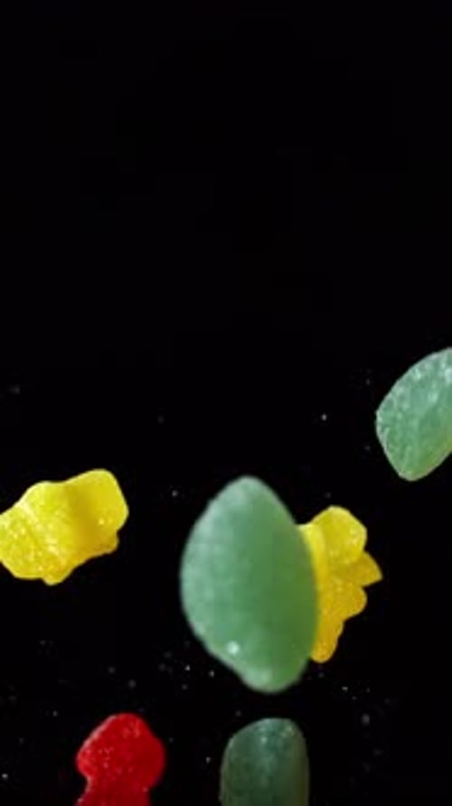 Floating Gummy Candies on a Black Background