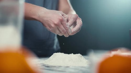Person Cracking Egg into Flour Pile