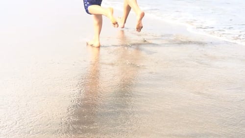 Couple of Joggers Running on Beach Active