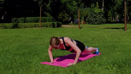 Athletic Woman Doing Push-Ups in Park