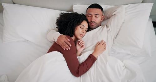 Comfortable Couple Sleeping Peacefully in White Bed