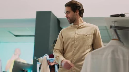 Shopping Center Worker Helping Client with Trendy Outfits