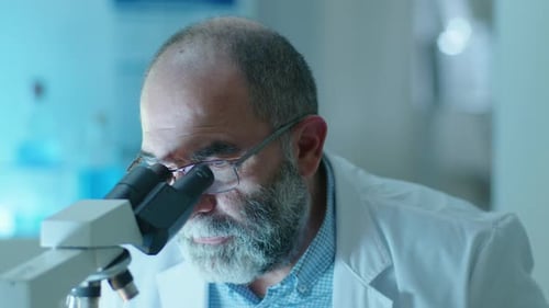 Close Up Scientist with Microscope in Lab