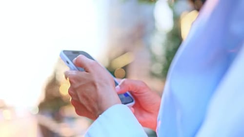 Extreme Closeup View of Hands of Attractive Young Caucasian Woman Using Smartphone Searching in