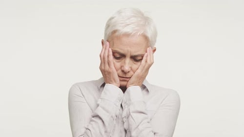 Senior Woman Expressing Sadness and Discomfort