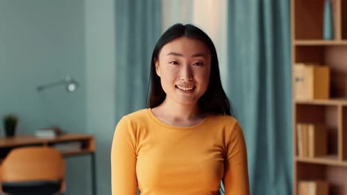 Smiling Young Woman in a Yellow Shirt