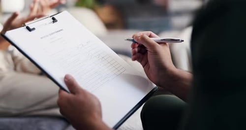 Doctor Fills Medical Questionnaire with Patient Present