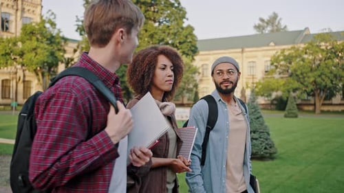 International Students with Backpacks Discuss Lectures