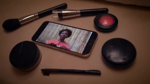 Makeup and Brushes With Phone Playing Video