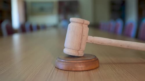 Wooden Gavel on Table in Empty Courtroom