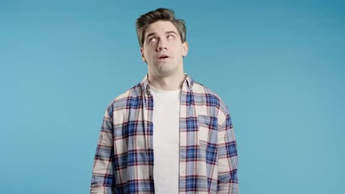 Man Looks Upward with an Unamused Expression