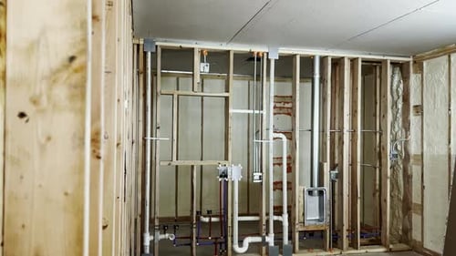Home Construction: Exposed Frame, Pipes, and Wiring