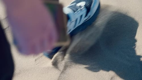 Footstep on Sand: Foot Wearing Shoe Steps on Sand