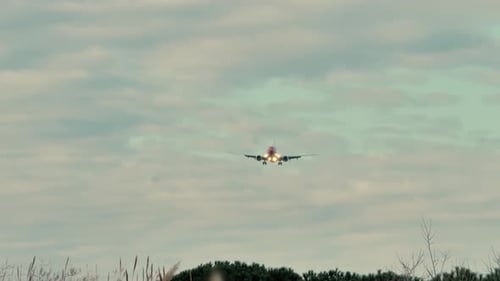 Airplane Approaching for Landing Under Cloudy Sky
