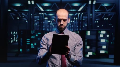 Man Working on Tablet in Server Room