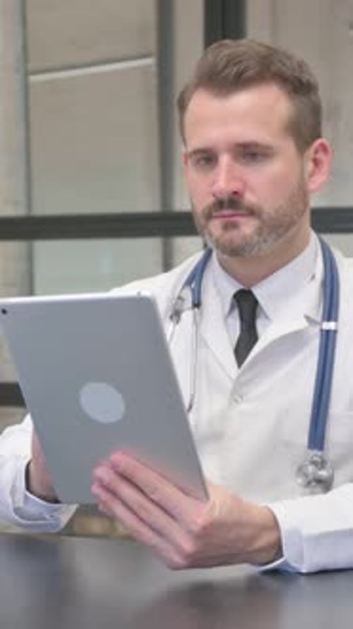 Doctor Using Tablet in Office