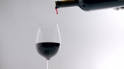 Red Wine Pouring Into Glass Close Up