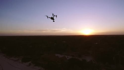 Aerial Drone Quad Copter Footage Flying Over Tropical Area And Towards The Sun.