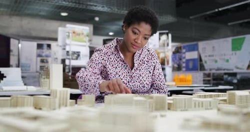 Architectural Student Working on a Building Model